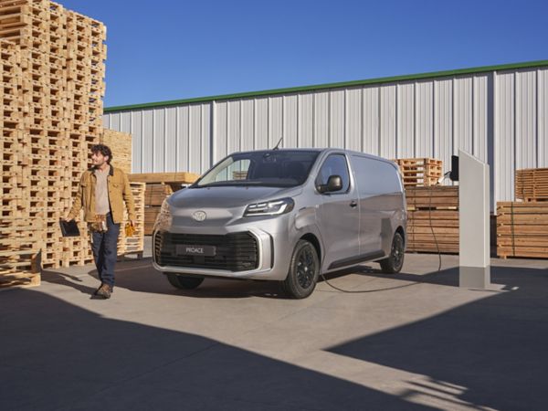 A Toyota Proace drives a long country road