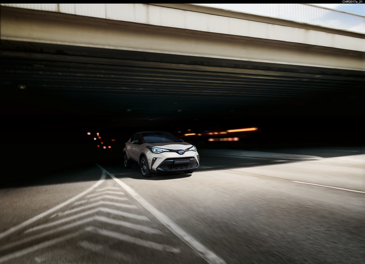 Toyota Corolla Hatchback driving down the road